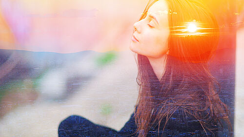 Double multiply exposure portrait of a dreamy cute woman meditating outdoors with eyes closed, combined with photograph of nature, sunrise or sunset. closeup. Psychology power of mind concept.